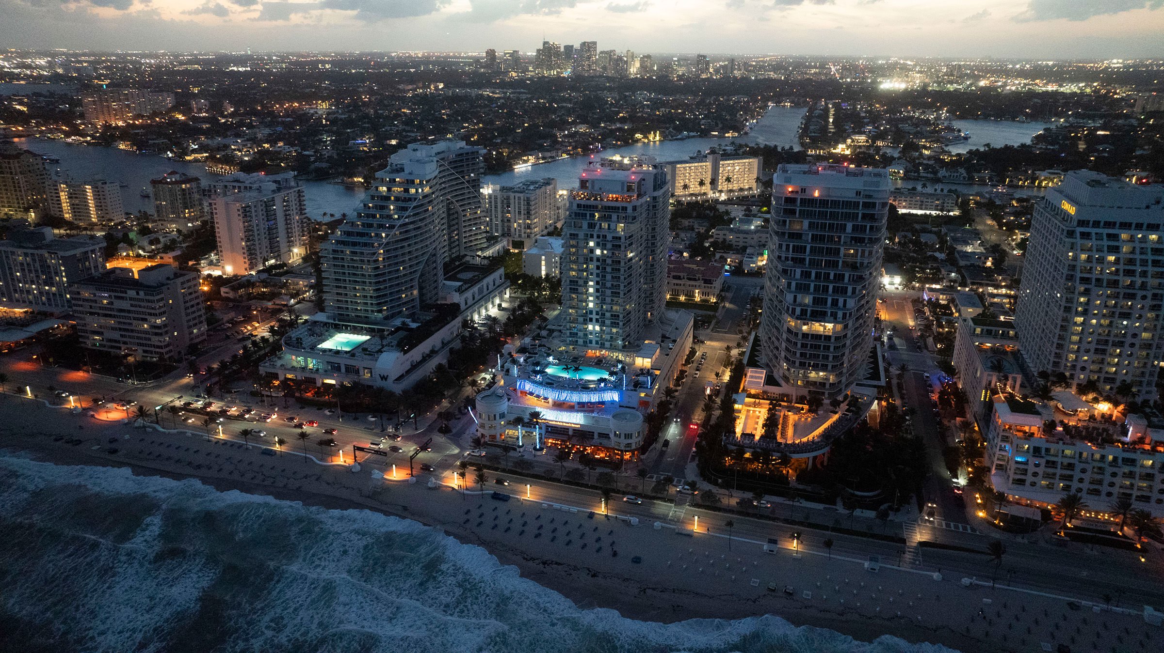 Aerial view of the resort at night, from the beach