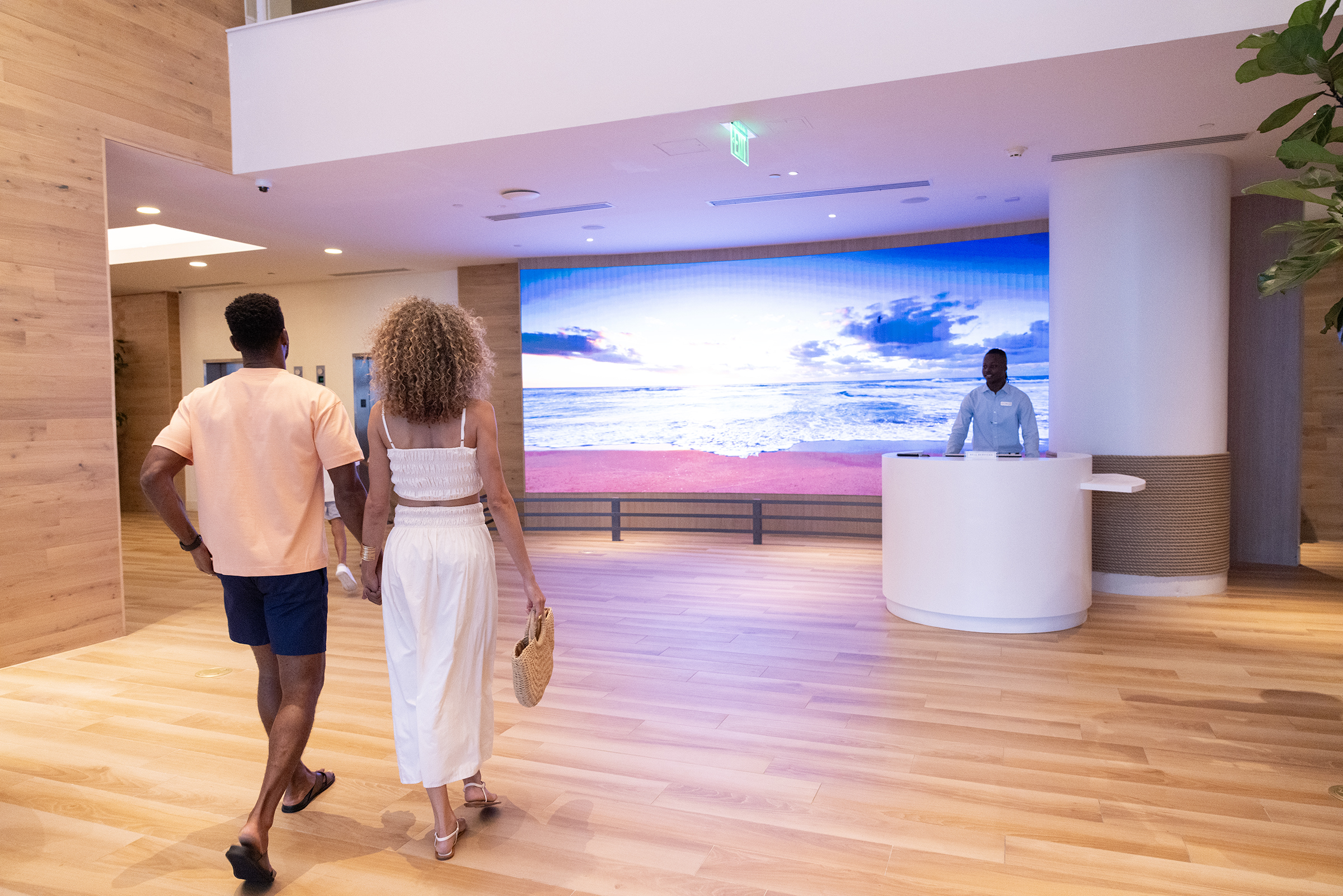 A couple walking into elevated resort lobby