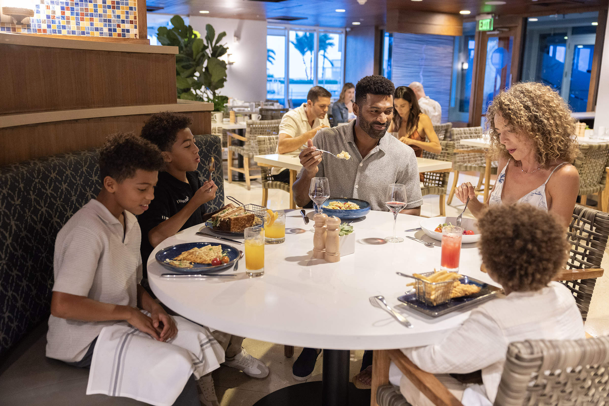 family of 5 eating at a white circular table