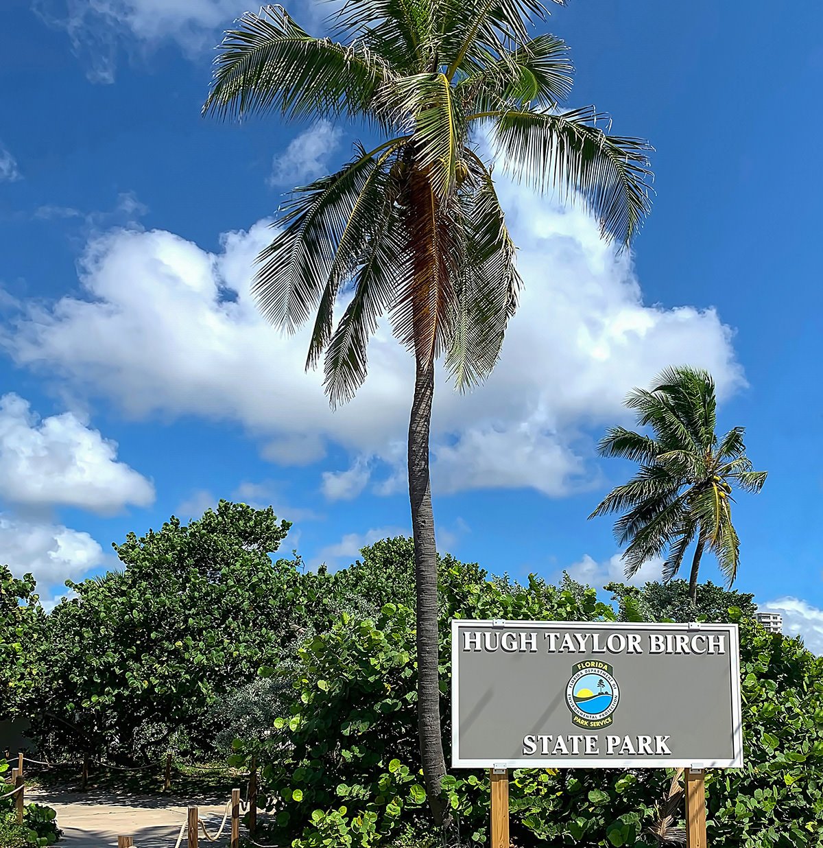 Entrance walkway and sign on A1A to Hugh Taylor Birch State Park a Florida State Public Park.