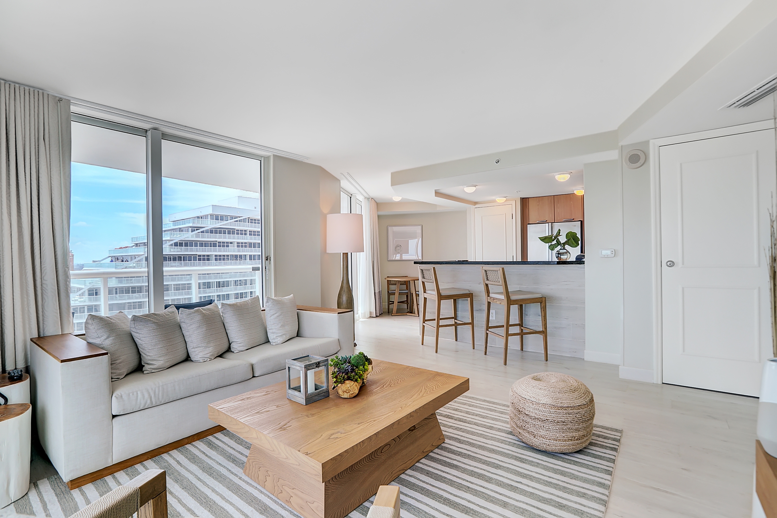 A large modern living room with island table and tall chairs