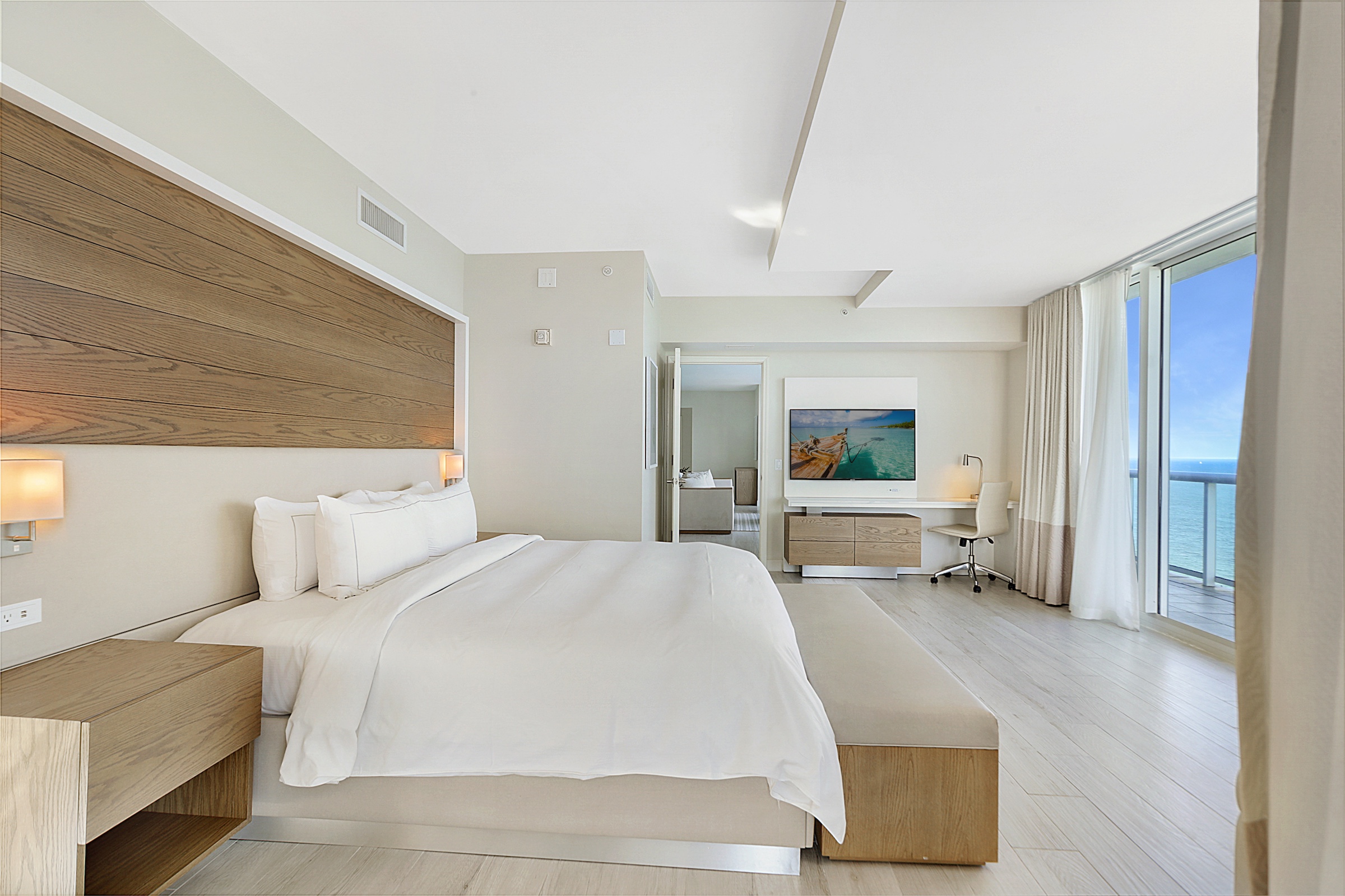 A bright spacious bedroom with a large king bed