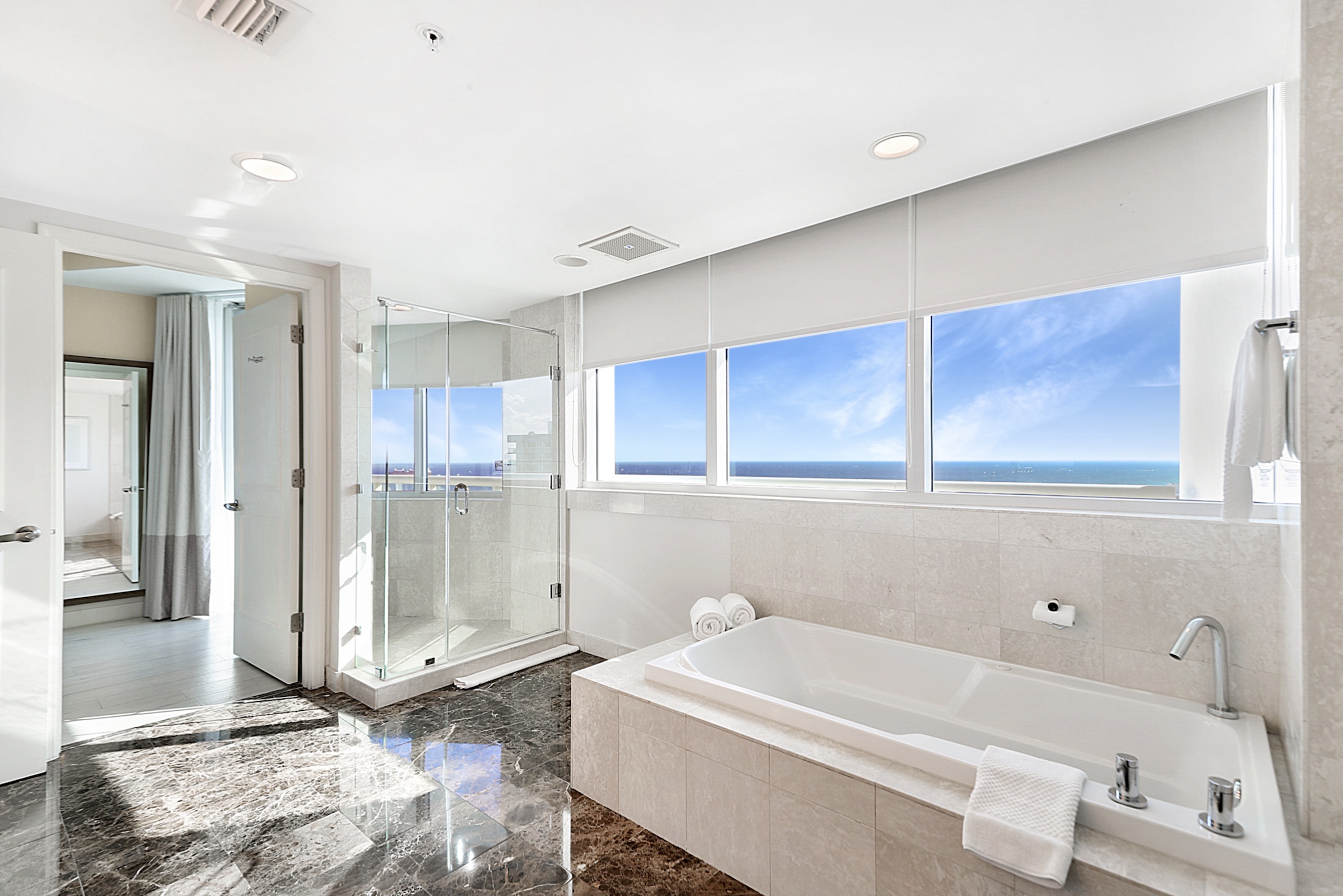 A bathroom with a large soaking tub and separate shower