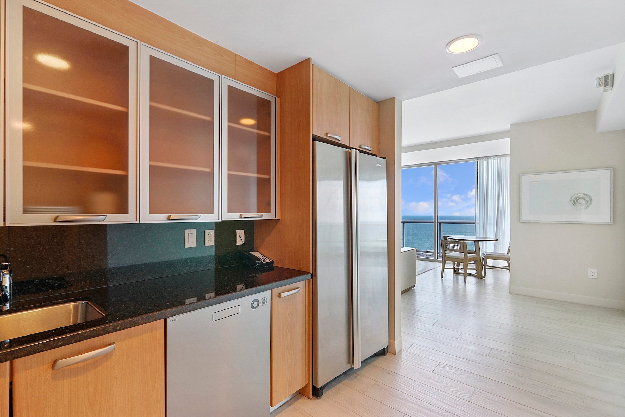 A kitchen with a full sized fridge and dishwasher