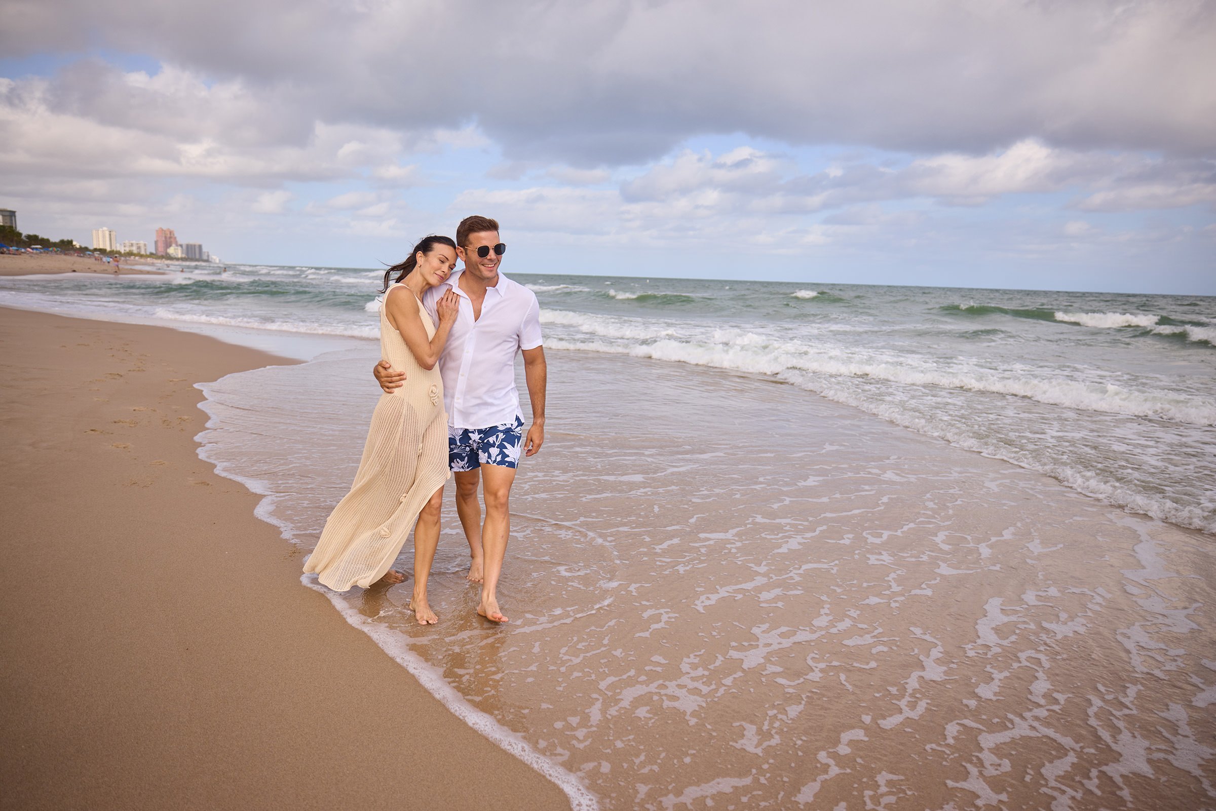 A couple walking on the beach in windy weather