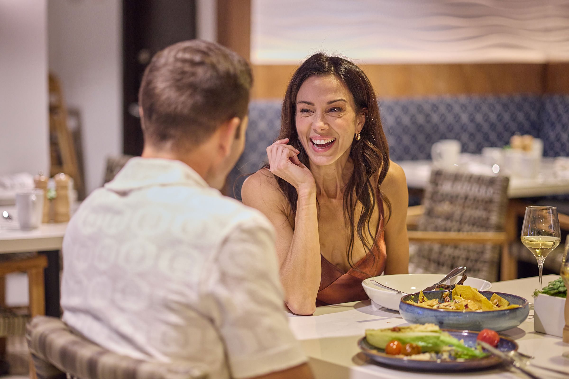 A couple dining in Ilios and enjoying their company and food