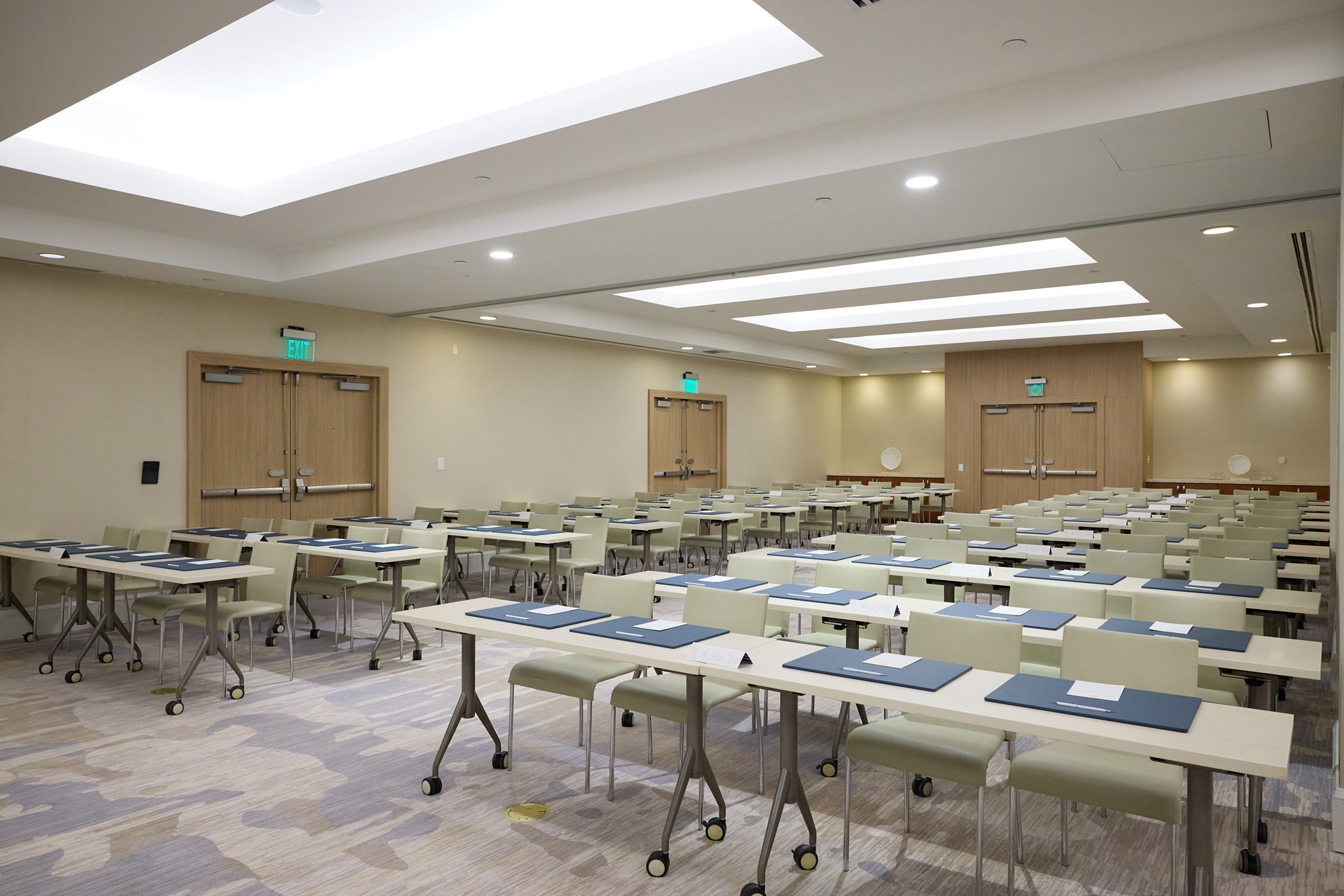 A formal large meeting venue with many desks and tables