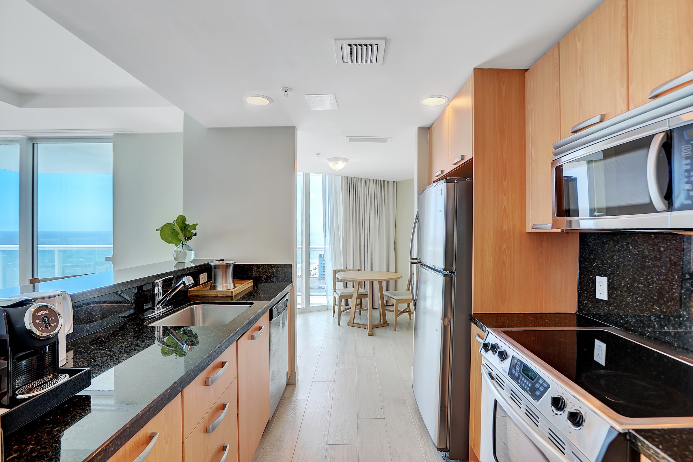 A galley kitchen next to a dining area