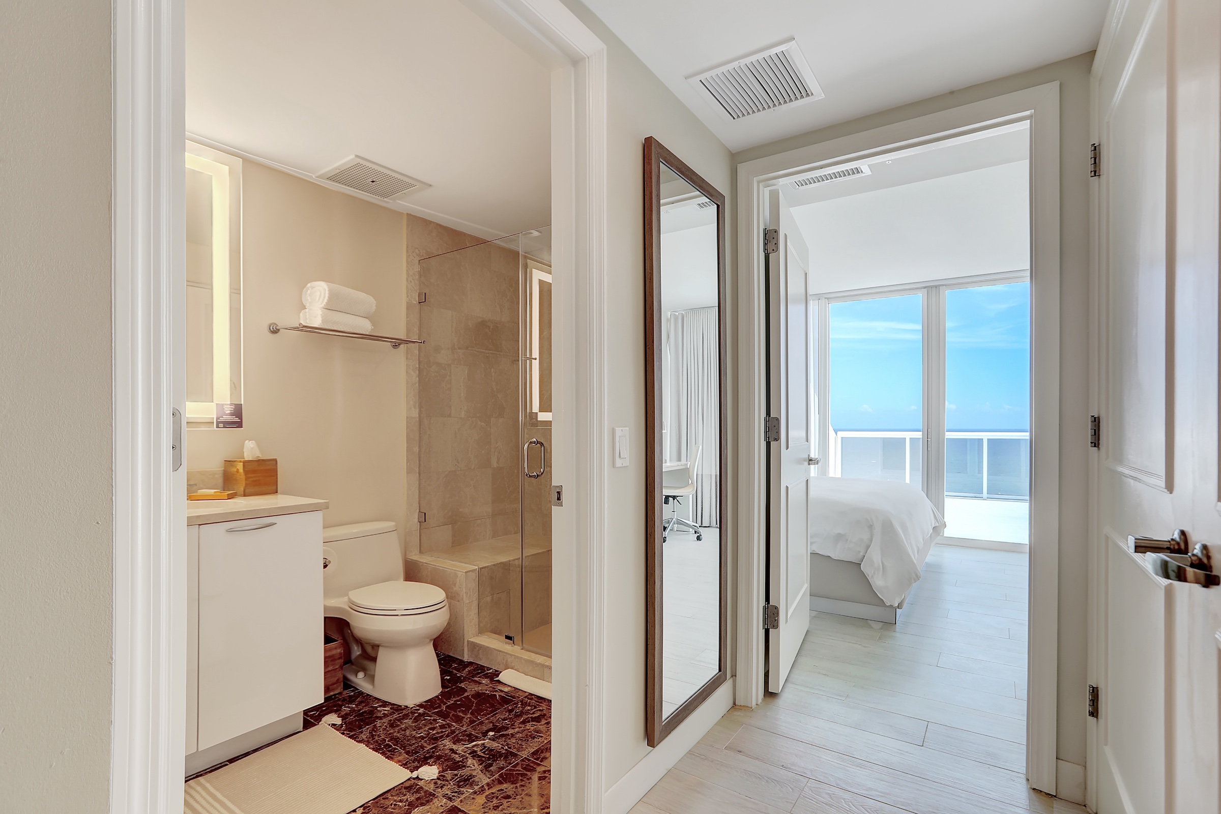 A powder room next to an oceanside bedroom