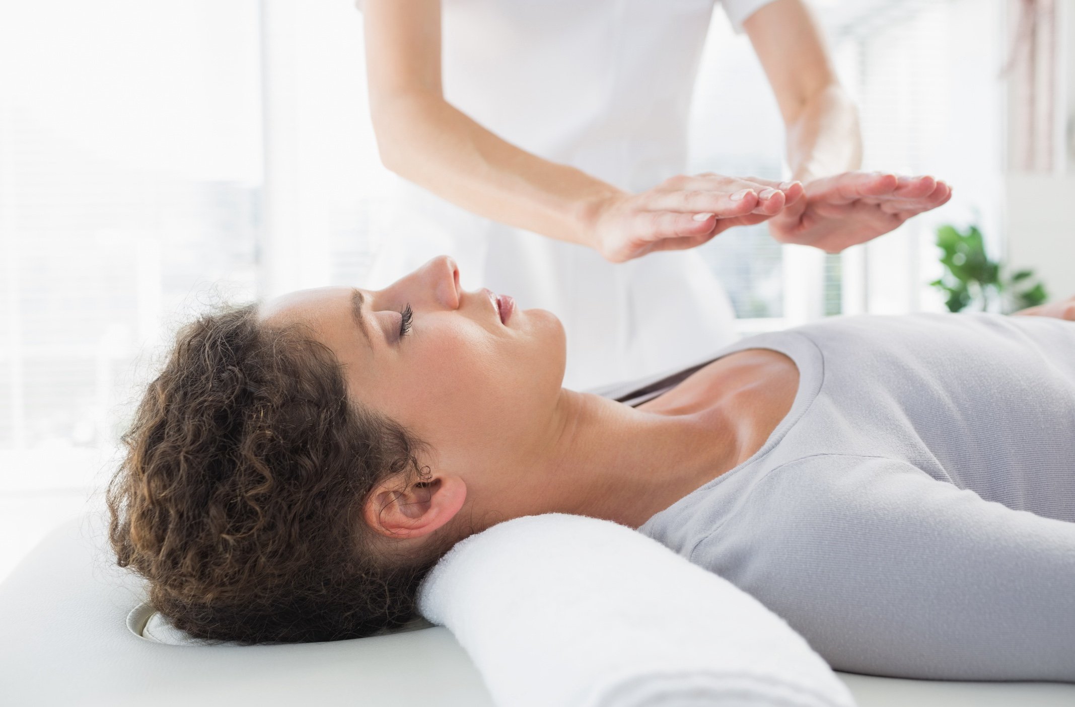 A woman receives Reiki massage treatment