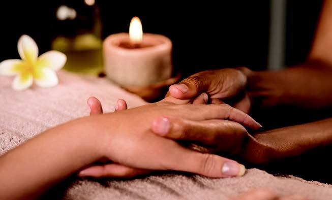 A person receiving a hand massage
