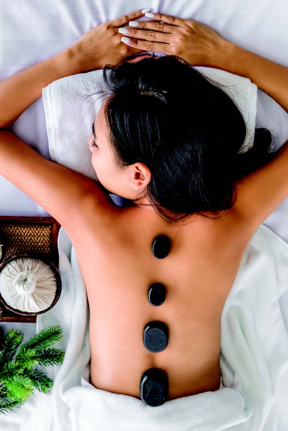 A person receiving hot stone treatment