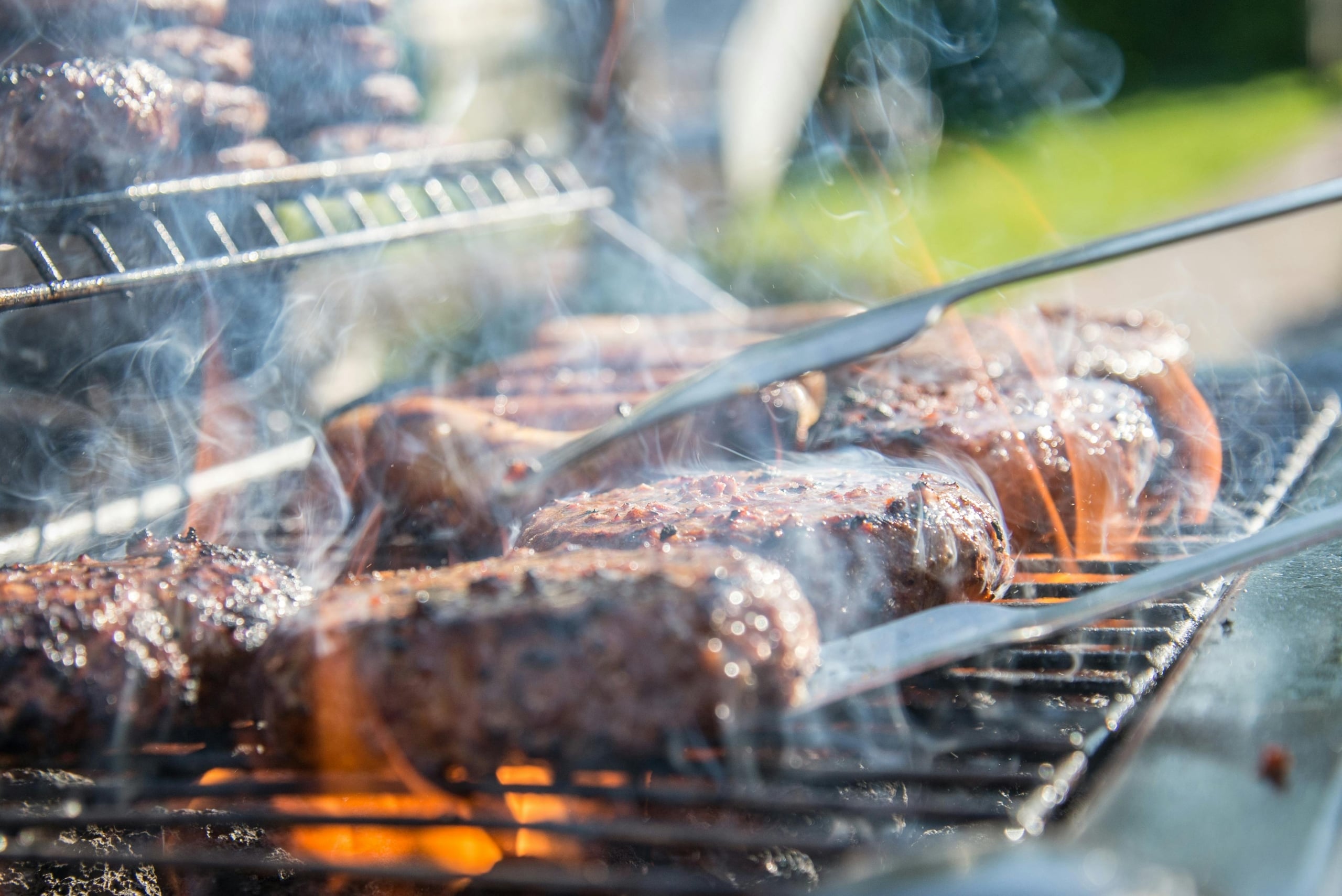 backyard barbecue with meats on the grill
