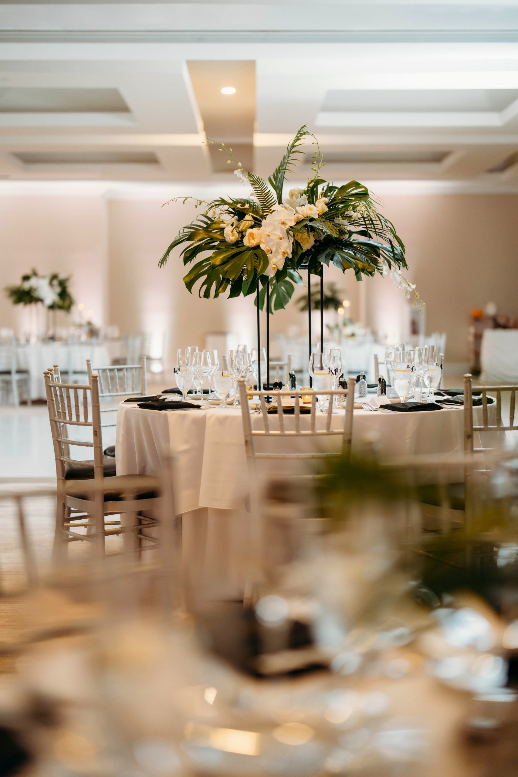 Hotel ballroom with tropical centerpiece in the middle of a round table